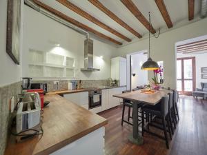 a kitchen with a table and a dining room at Barcelonaforrent Alessandra Central Ramblas Apartment in Barcelona