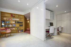 an open room with a desk and chairs and a computer at Bourke Street Urban Retreat in Melbourne