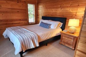 a bedroom with a bed in a log cabin at Good Hart Haven in Harbor Springs