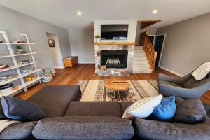 a living room with a couch and a fireplace at Good Hart Haven in Harbor Springs