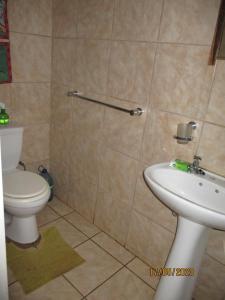 a bathroom with a toilet and a sink at Lutea Guest House in Mokopane