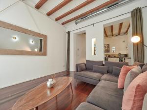 sala de estar con sofá y mesa en Barcelonaforrent Alessandra Central Ramblas Apartment en Barcelona