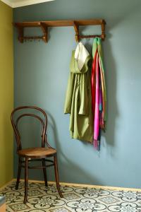 a room with a chair and a coat hanging on a wall at Haus Hedwig in Heringsdorf