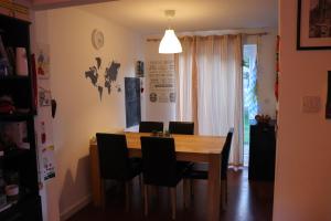 a dining room with a wooden table and chairs at TULLIS Town House - Glasgow Green in Glasgow