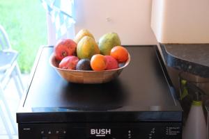 a bowl of fruit sitting on top of a microwave at TULLIS Town House - Glasgow Green in Glasgow