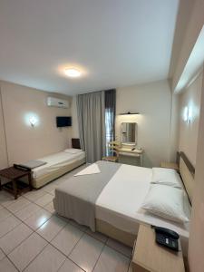 Posteľ alebo postele v izbe v ubytovaní Hotel Afrodite