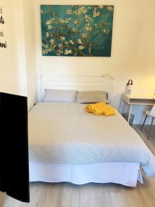 a bedroom with a bed with a yellow blanket on it at Casa di Arianna in centro storico a Vimercate in Vimercate