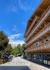 a building on a street with a mountain in the background at Apartments Austria in Söll