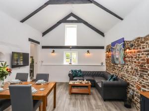 a living room with a couch and a table at Strawberry Bank - Kingfisher in Holsworthy