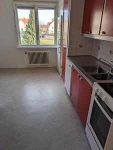 an empty kitchen with a sink and a window at Nära till allt in Jönköping