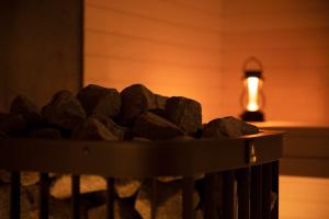 a pile of rocks on a grill with a light at 穴吹邸 / ANABUKI-TEI in Takamatsu