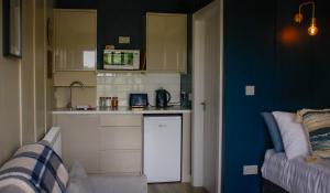 a small kitchen with a sink and a counter at Saul Lodges 