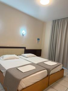 Posteľ alebo postele v izbe v ubytovaní Hotel Afrodite