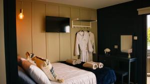 a room with a bed and a dress hanging on a wall at Saul Lodges in Saul