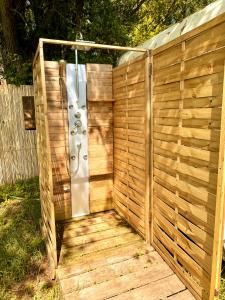 a wooden privacy fence with a shower in it at La « Ravane » in Cysoing