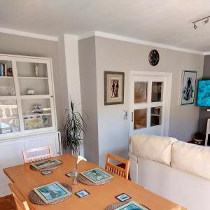 a living room with a table and a couch at Las Tres Mimosas in San Vicente de la Barquera