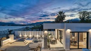 a house with a view of the water at Villa V Beach Villa, All Inclusive Board, by ZanteWize in Laganas
