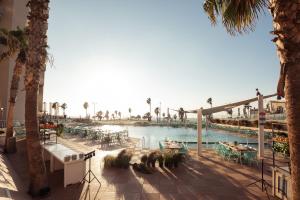 a view of the pool at the resort at Dan Panorama Tel Aviv Hotel in Tel Aviv