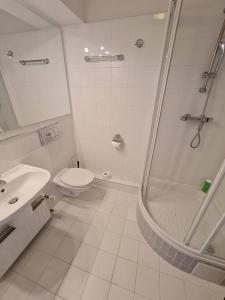 a bathroom with a shower and a toilet and a sink at 10Q - Z6 Apartment 304 in Warsaw