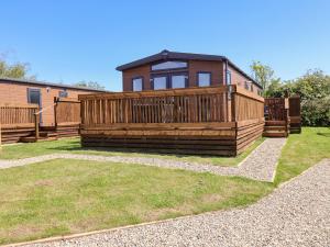 a house with a large deck on the grass at Foxglove Lodge in Saltburn-by-the-Sea