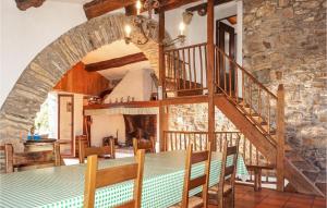 a dining room with a table and a spiral staircase at 2 Bedroom Amazing Home In Olargues in Olargues