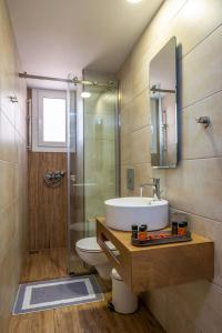 a bathroom with a sink and a toilet and a shower at Santa Elena Boutique Rooms in Chania