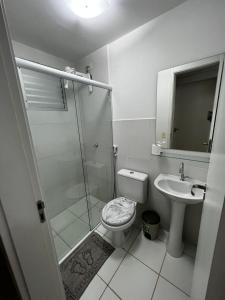 a bathroom with a shower and a toilet and a sink at Apartamentos da Thay in Campina Grande