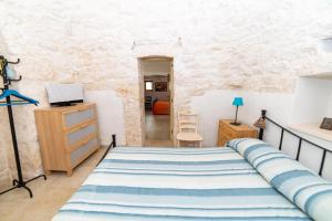 a bedroom with a bed in a room at Trulli Villa Rosa Lia in Martina Franca
