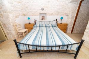 a bedroom with a large bed in a room at Trulli Villa Rosa Lia in Martina Franca