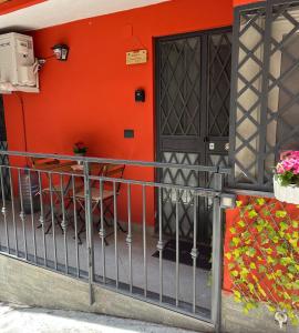 un bâtiment avec un mur orange et une table sur un balcon dans l'établissement Amuri di Casa Catania, à Catane