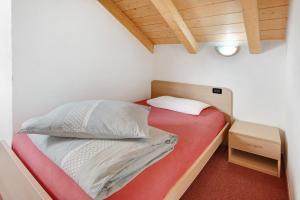 A bed or beds in a room at Baita Truzz appartamento Valle