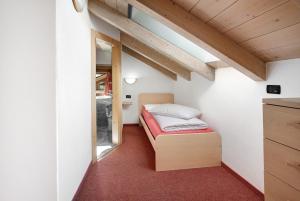 A bed or beds in a room at Baita Truzz appartamento Valle