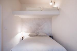 a white bedroom with two bunk beds in it at Eden in Athens