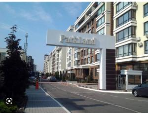 a sign for a apartment building on a city street at Residential complex Parkland in Kyiv