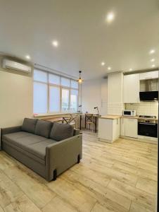 a living room with a couch and a kitchen at Residential complex Parkland in Kyiv