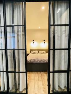a bedroom with a bed through a glass door at Residential complex Parkland in Kyiv