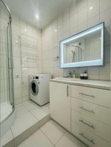 a bathroom with a washing machine and a washer at Residential complex Parkland in Kyiv