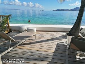 a view of the ocean from the deck of a resort at Love Beach Loft in Marigot