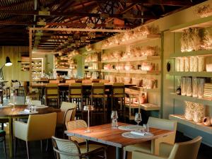 a restaurant with tables and chairs and shelves with vases at Lavandeira Douro Nature & Wellness in Baião