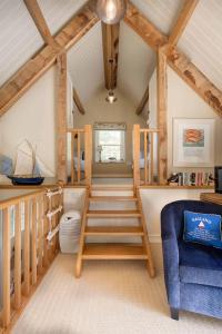 a room with a loft with a toilet and a chair at Vine House in Salcombe