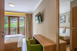 a hotel room with a bed and a desk at Sairme Hotels & Resorts in Sairme