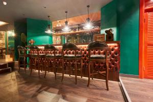 a row of chairs in a bar with green walls at Azuu Boutique Hotel in Antalya