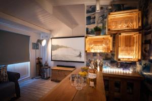 a room with a table with wine bottles and glasses at Treetops in Salcombe