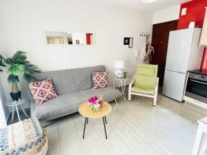 a living room with a couch and a table at Cozy Nest - 2min To Beach, 6min Walk To Old Town in Chania