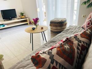 a living room with a couch and a table at Cozy Nest - 2min To Beach, 6min Walk To Old Town in Chania