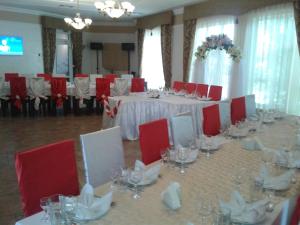 a room with a table with red chairs and a room with at Status Hotel in Poltava