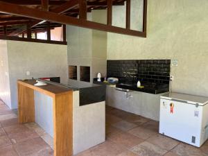 a kitchen with a stove and a refrigerator at Flat Praia da Taíba - com vista Mar in Taíba