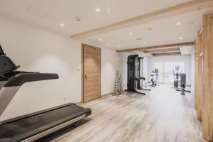 a gym with treadmills and a treadmill at FIRSTpeak Appartements und Chalets in Zauchensee