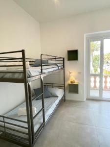 Ένα ή περισσότερα κρεβάτια σε δωμάτιο στο Poetto Beach House-Ausonia