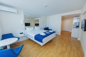 a bedroom with a bed and a table and chairs at Orbi City Luxury Towers in Batumi